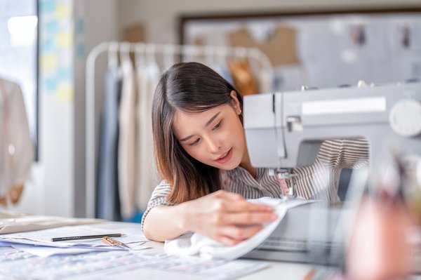 Which UK cities offer guided tours of historic textile mills?
